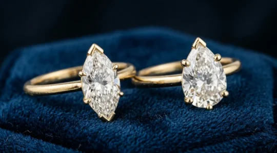 Elegant marquise and pear cut diamonds displayed with protective V-prong settings in a jewelry atelier