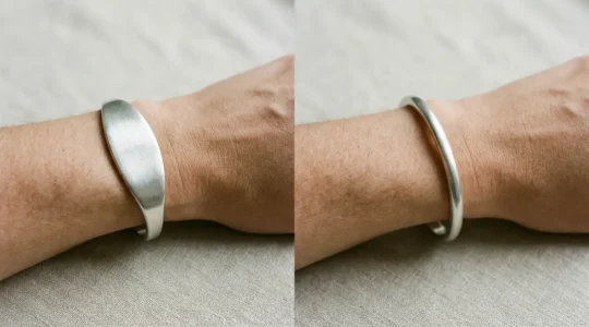 Close-up comparison of oval and round cuff bracelets on a wrist showing fitting differences